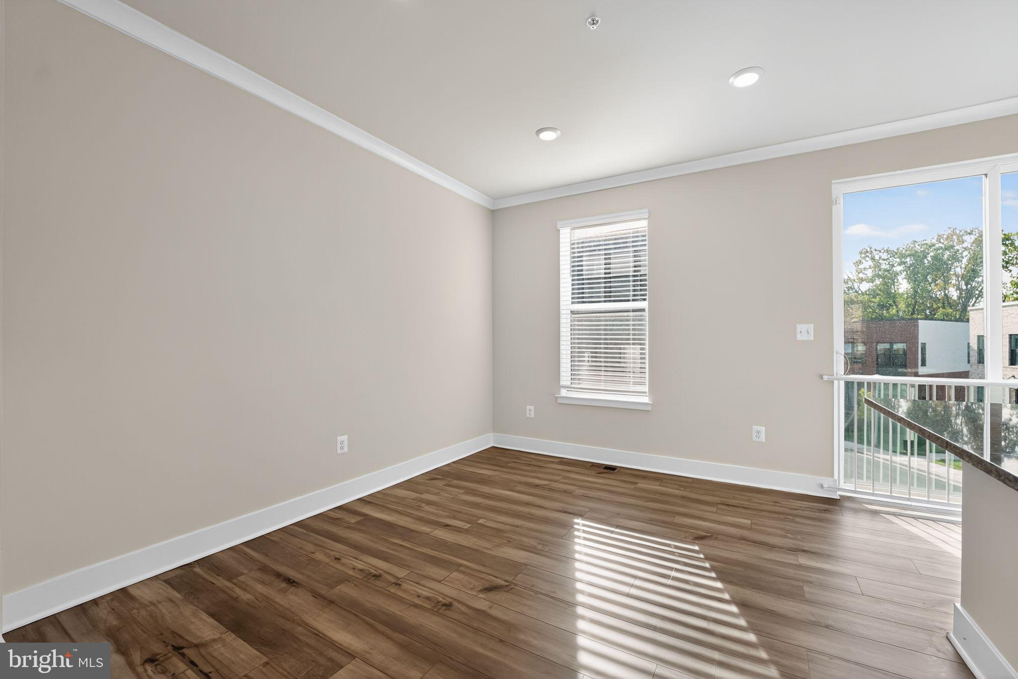1511 Roland Heights Avenue Baltimore, MD 21211 - Photo 13 of 42 wooden floor in an empty room with a window