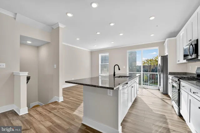 a kitchen with stainless steel appliances granite countertop a sink and stove