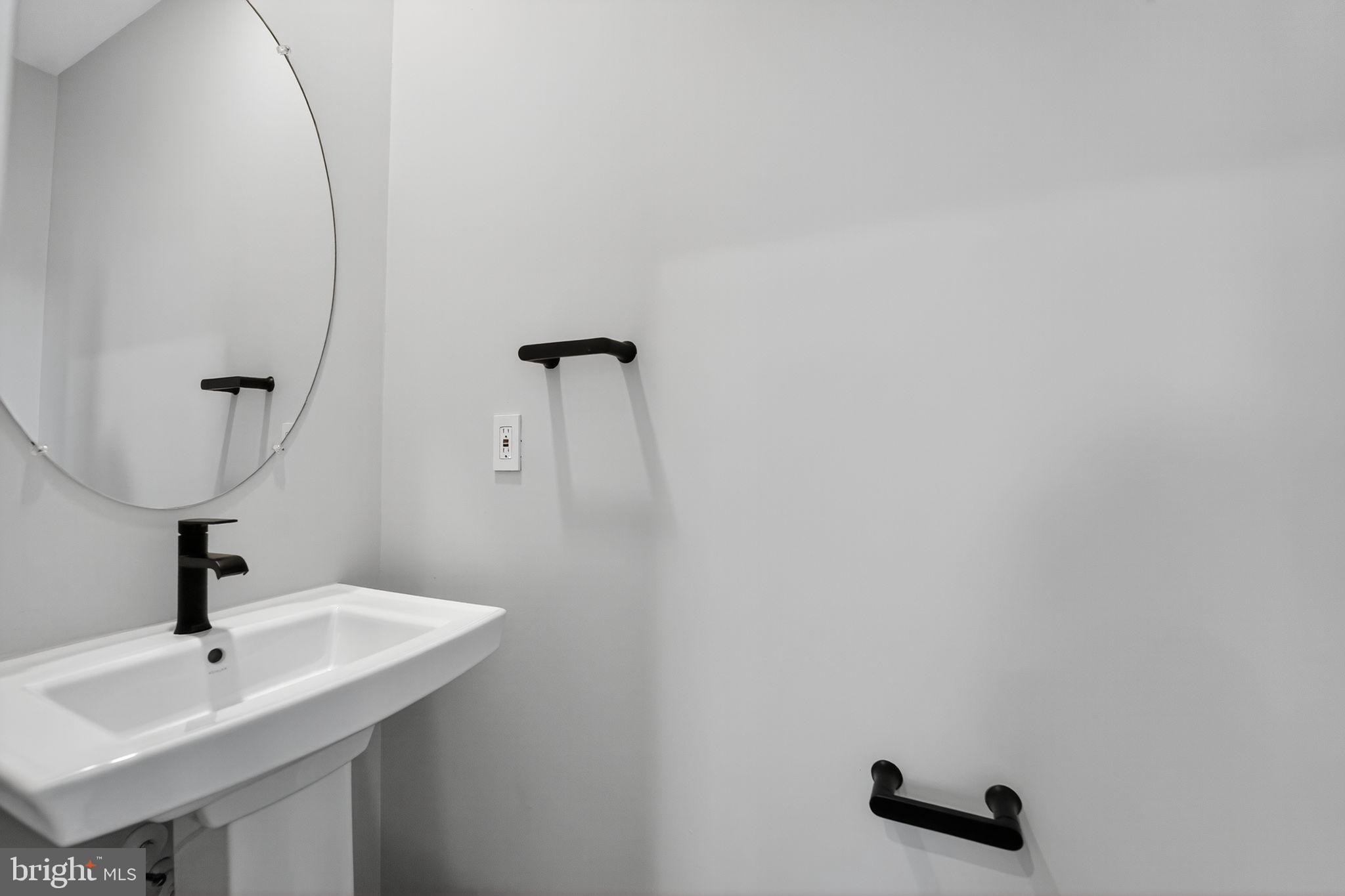 1511 Roland Heights Avenue Baltimore, MD 21211 - Photo 23 of 42 a bathroom with a sink and a mirror