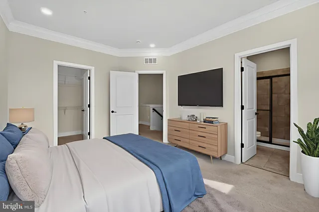 a bedroom with a bed and a flat screen tv in it