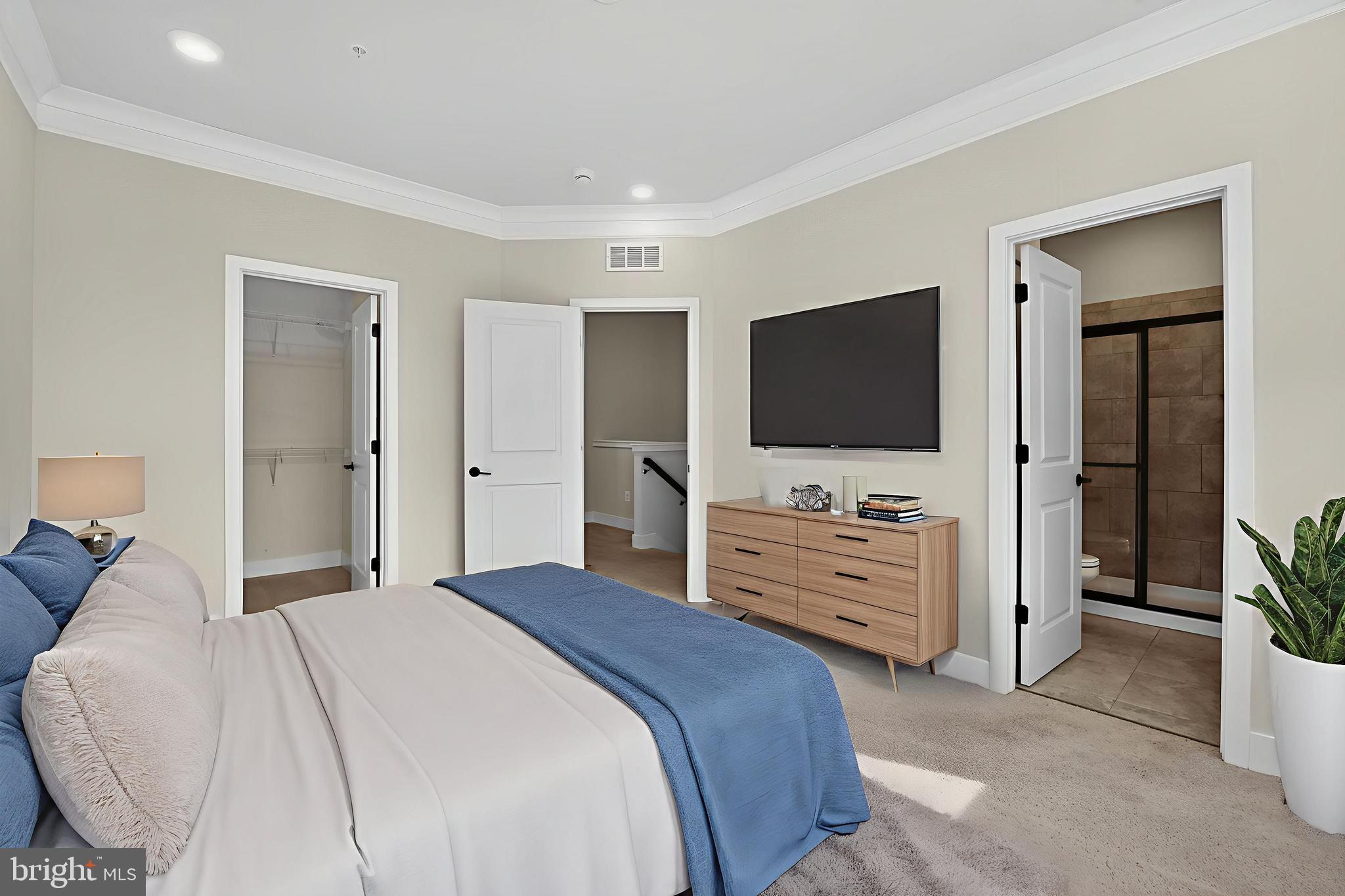 1511 Roland Heights Avenue Baltimore, MD 21211 - Photo 25 of 42 a bedroom with a bed and a flat screen tv in it