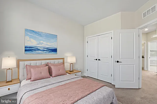a bedroom with a bed and a painting on the wall