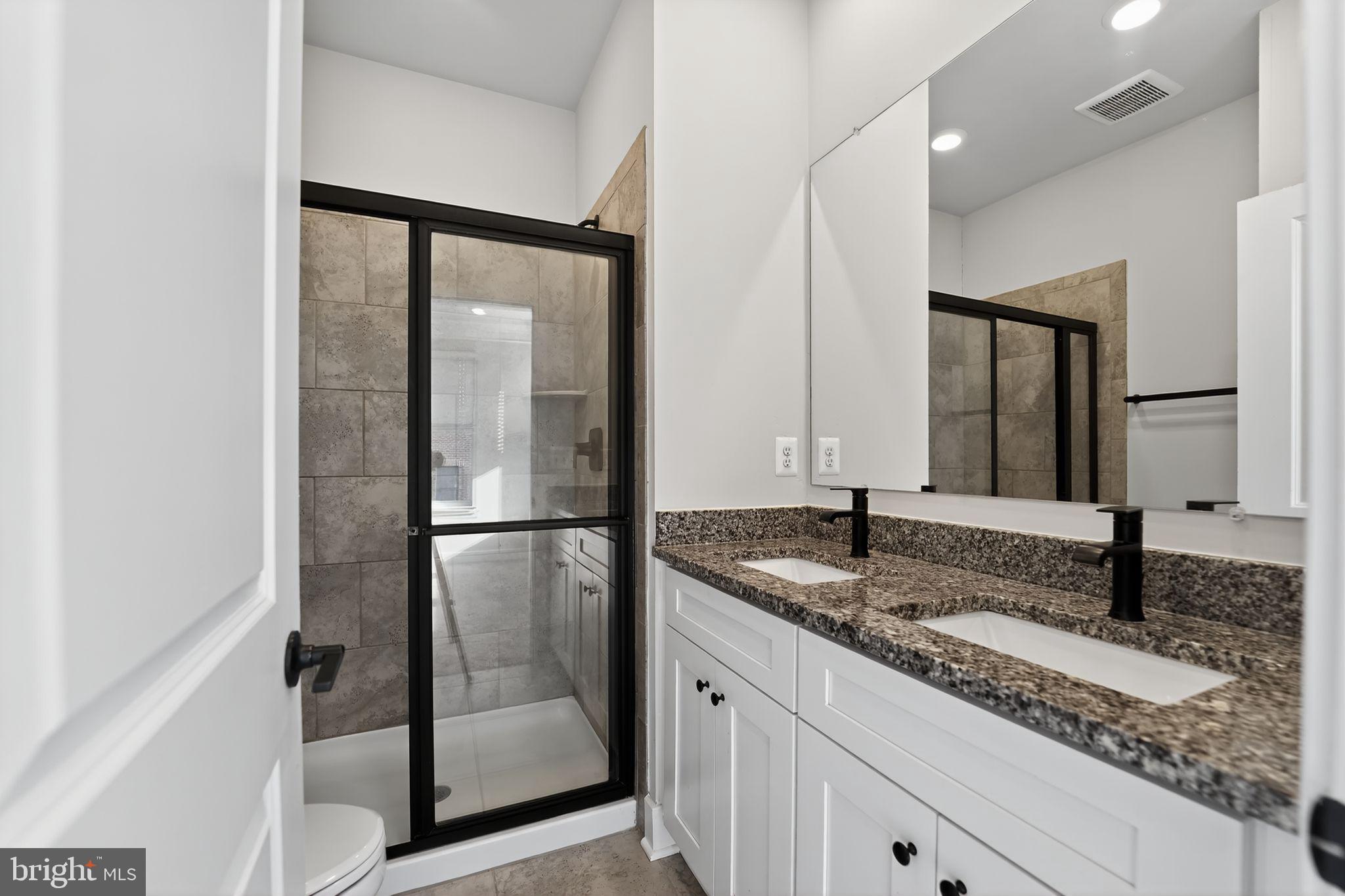1511 Roland Heights Avenue Baltimore, MD 21211 - Photo 36 of 42 a bathroom with a granite countertop sink and a mirror