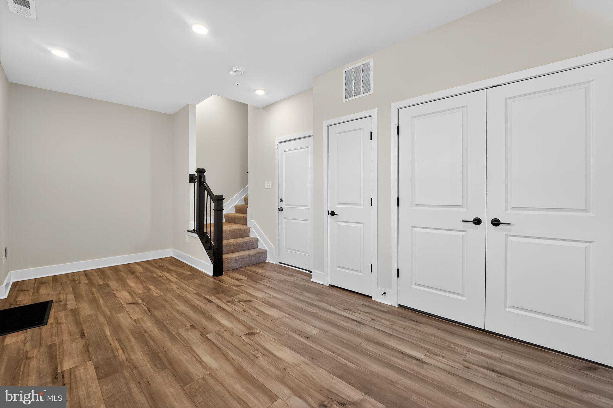 1511 Roland Heights Avenue Baltimore, MD 21211 - Photo 41 of 42 a view of an empty room with wooden floor