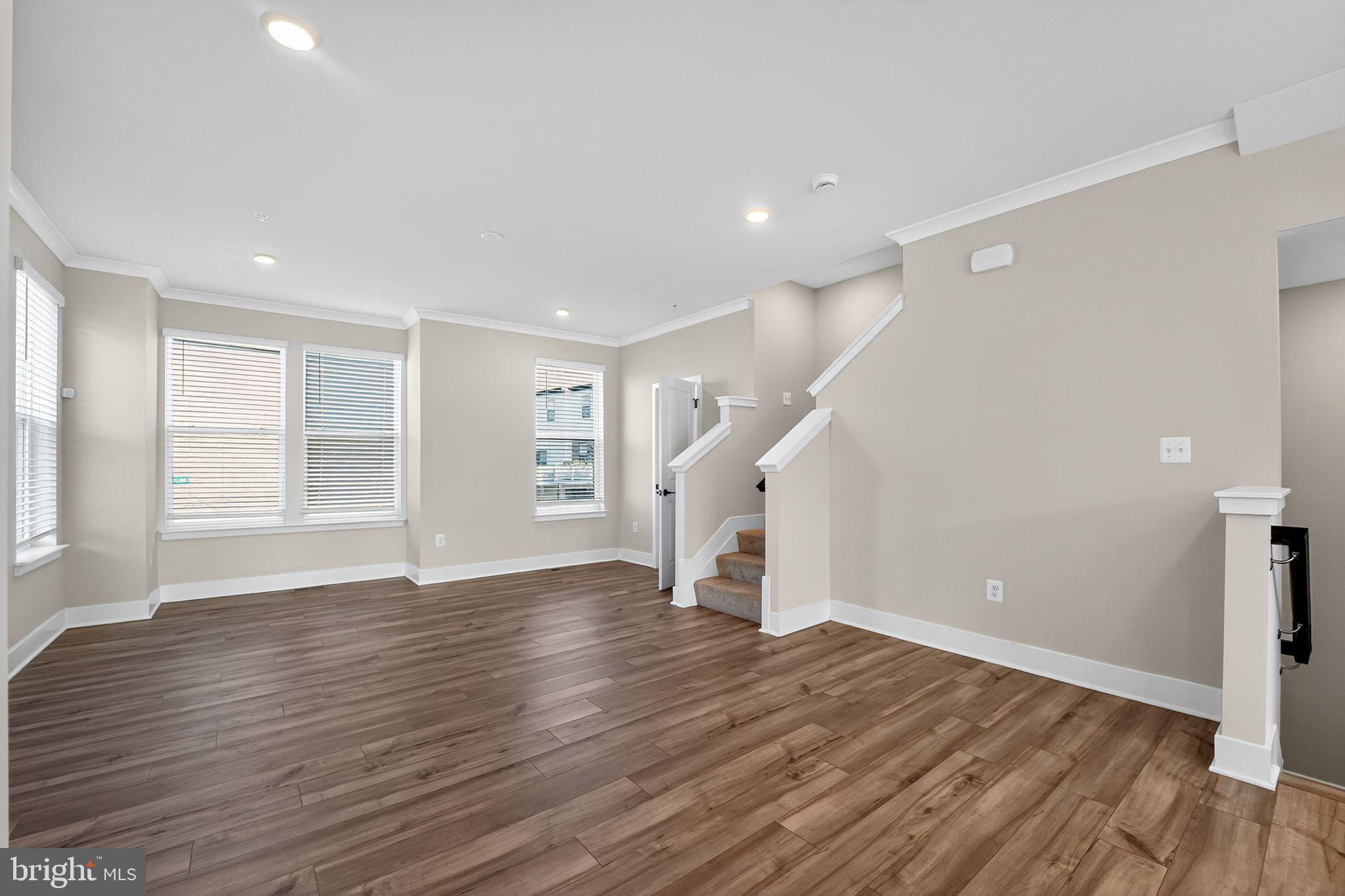 1511 Roland Heights Avenue Baltimore, MD 21211 - Photo 5 of 42 a view of empty room with wooden floor and fan
