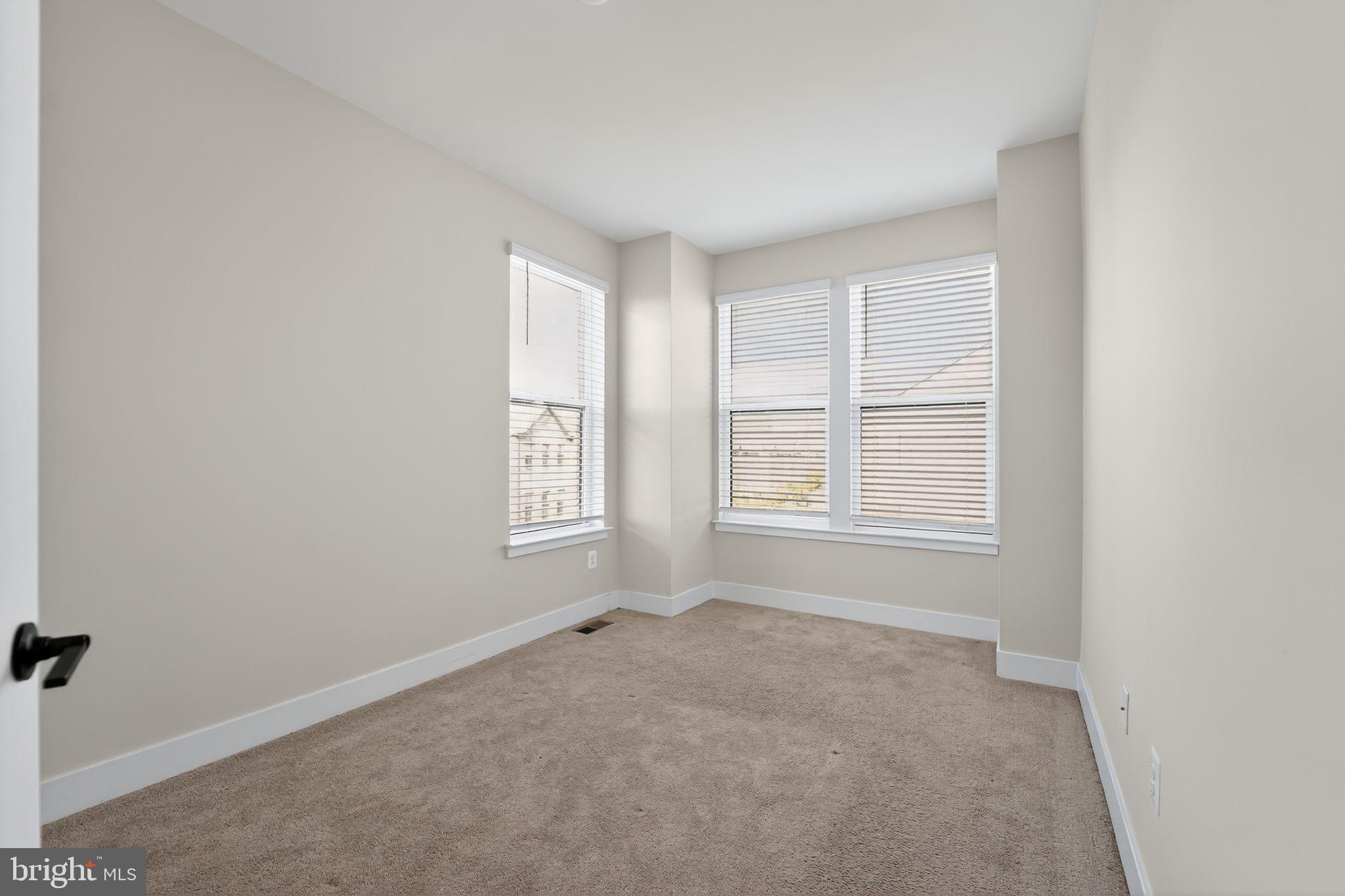 1511 Roland Heights Avenue Baltimore, MD 21211 - Photo 9 of 42 an empty room with windows