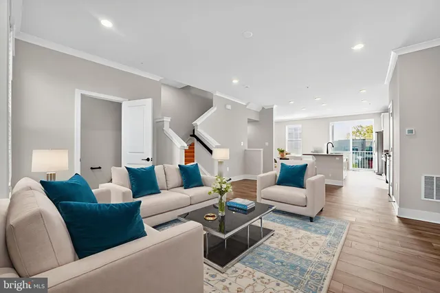 a living room with furniture and wooden floor