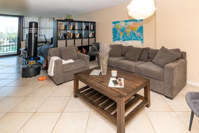 a living room with furniture a bookshelf and a book shelf