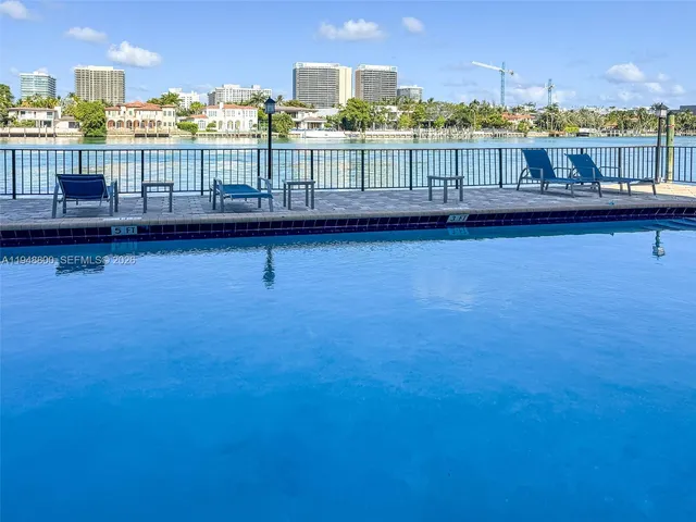 a view of a lake with tall building in front of house