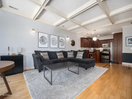 a living room with furniture and kitchen view