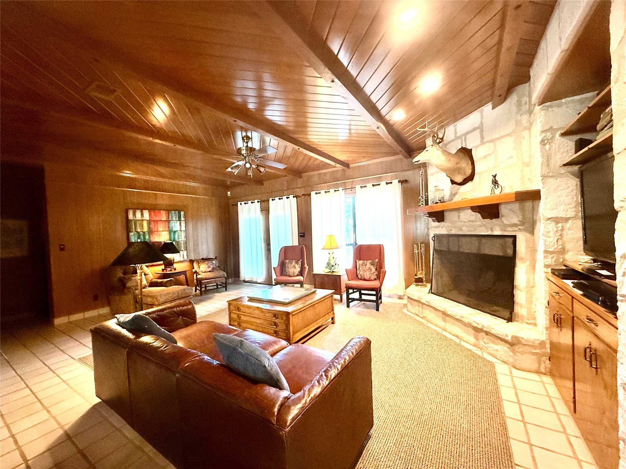 9030 River Road New Braunfels, TX 78132 - Photo 13 of 25 a living room with furniture a fireplace and a flat screen tv
