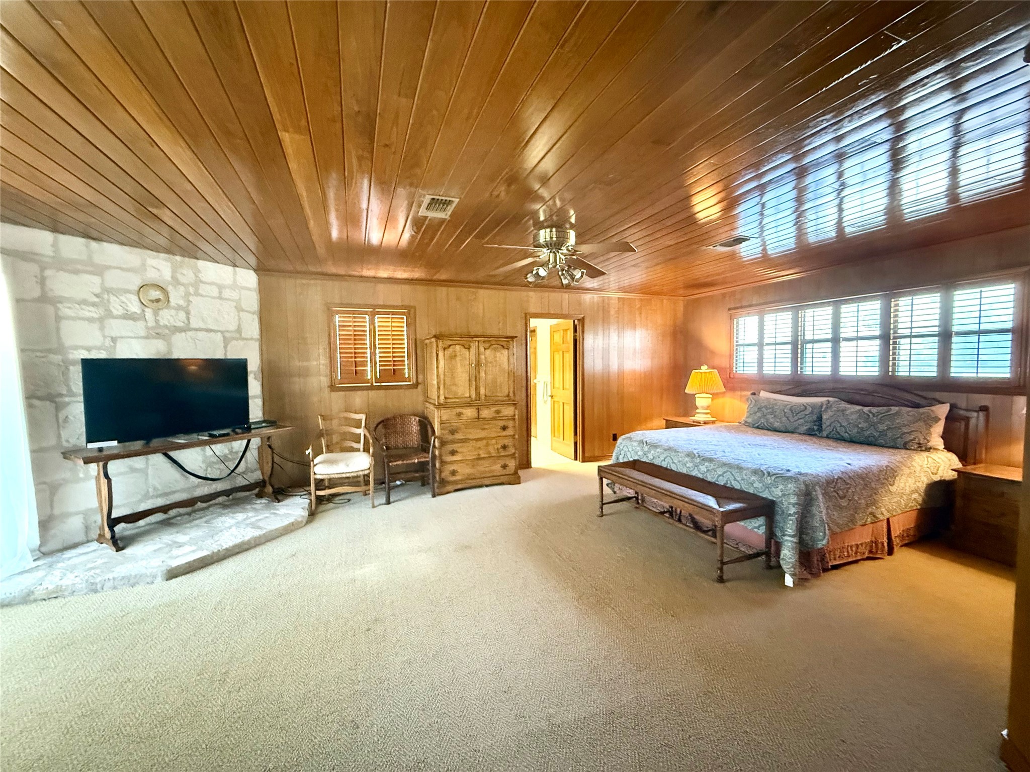 9030 River Road New Braunfels, TX 78132 - Photo 18 of 25 a spacious bedroom with a bed and large windows