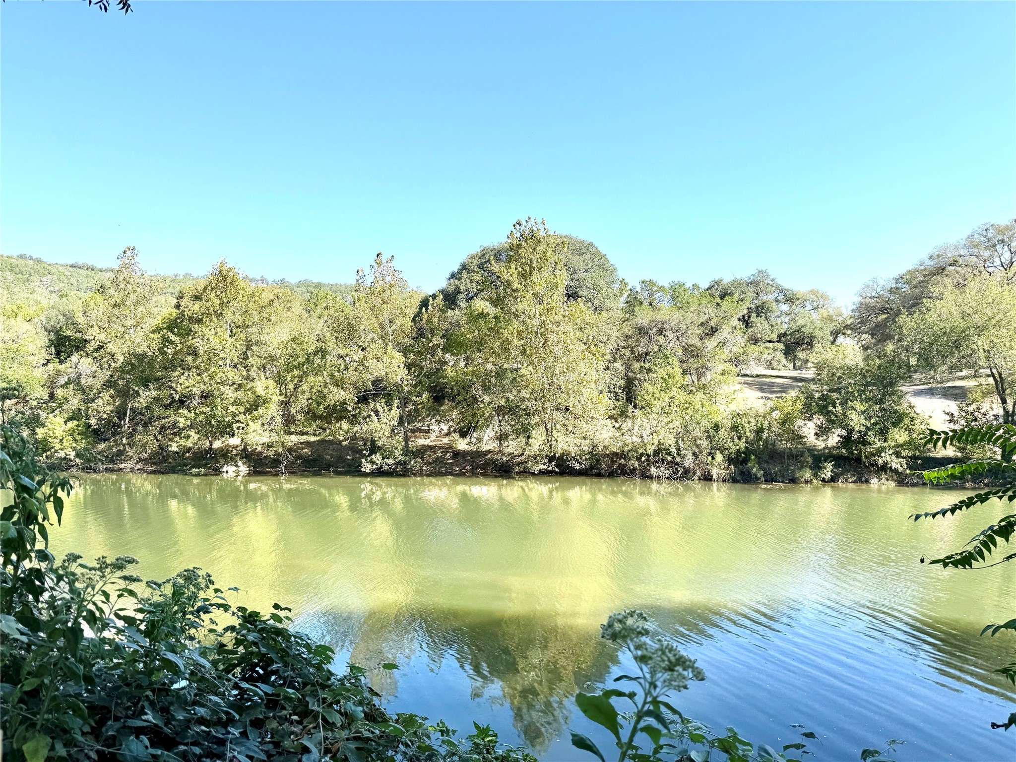 9030 River Road New Braunfels, TX 78132 - Photo 8 of 25 a view of a lake with a mountain in the background