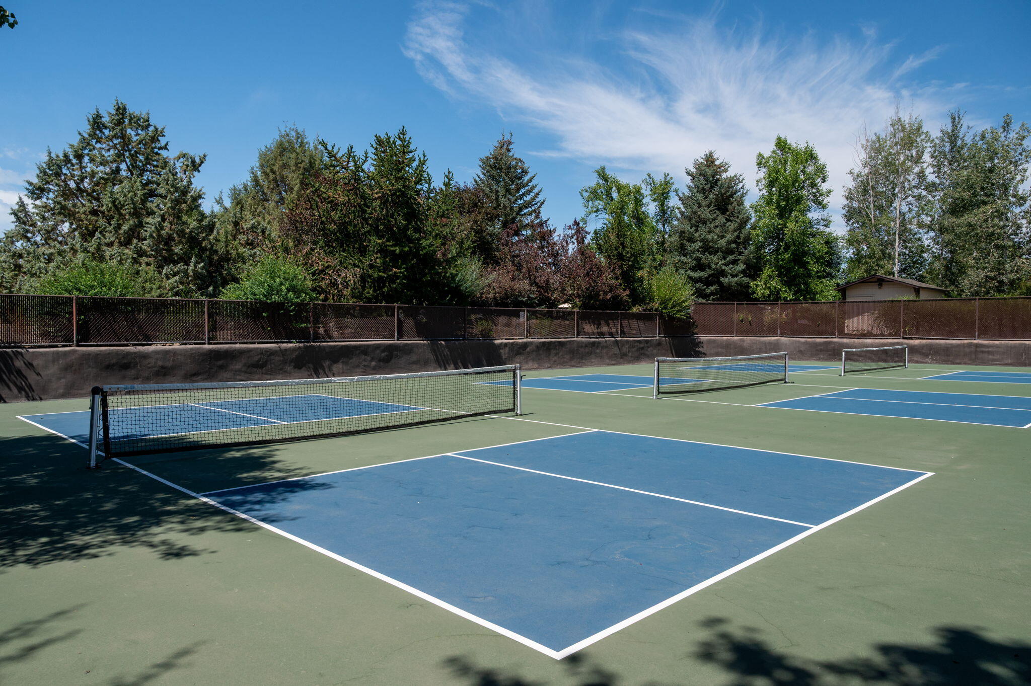 22936 Ghost Tree Lane Bend, OR 97701 - Photo 70 of 74 a view of tennis court with trees in the background