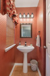 a bathroom with a sink toilet and mirror
