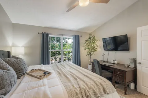 a bedroom with a bed and a flat screen tv