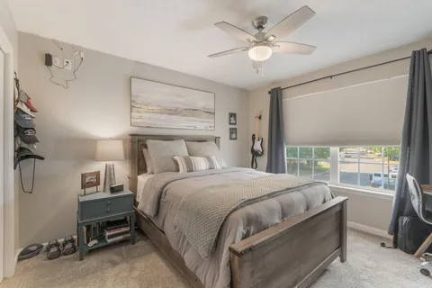 a bedroom with a large bed and a large window