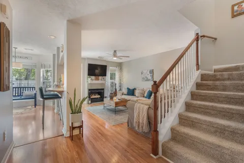 a view of entryway livingroom and hall with wooden floor