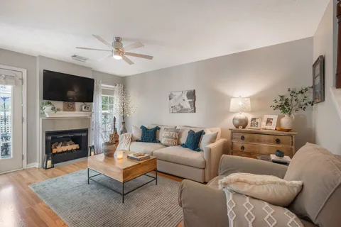 a living room with furniture a flat screen tv and a fireplace