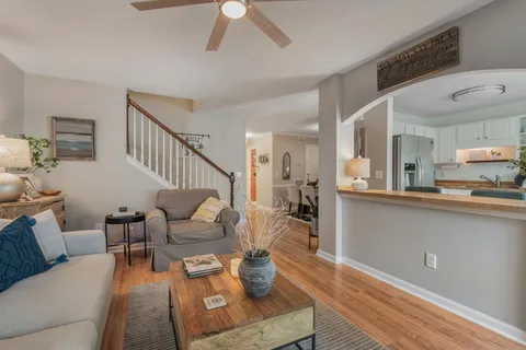 a living room with furniture and a wooden floor
