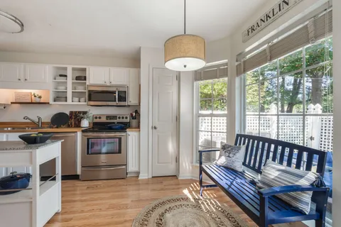 a view of kitchen with sink microwave and outdoor view