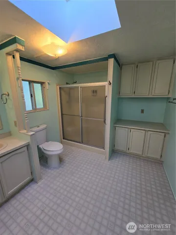 a bathroom with a sink a toilet and shower