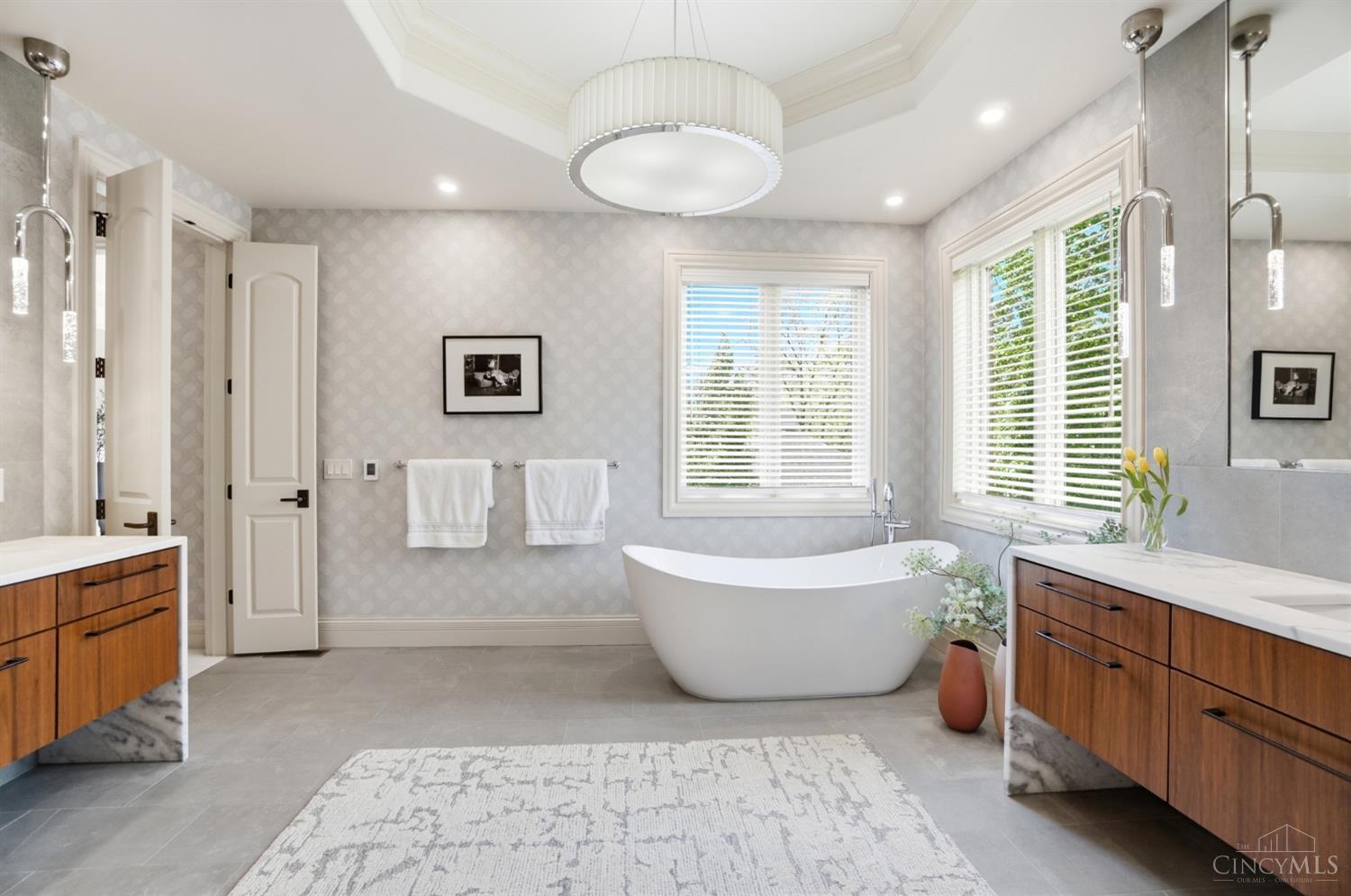 4535 Drake Road Cincinnati, OH 45243 - Photo 36 of 96 The primary bathroom boasts a soaking tub, shower, dual vanity and water closet.