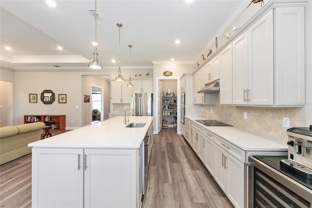 8843 Southwest 57th Pl Road Ocala, FL 34481 - Photo 15 of 64 a large white kitchen with a large window a sink and stainless steel appliances