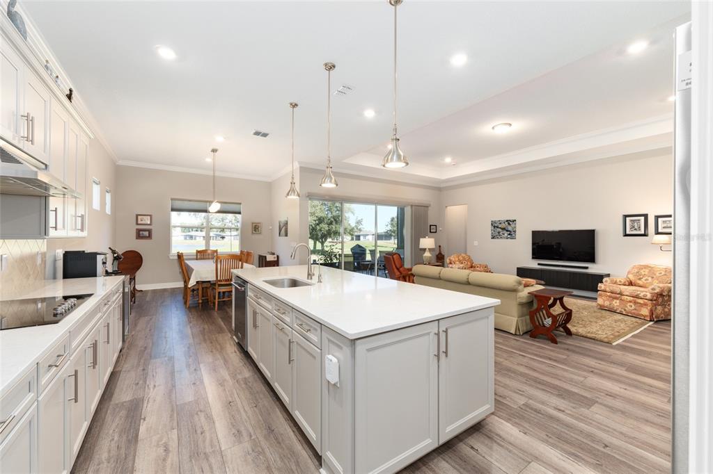 8843 Southwest 57th Pl Road Ocala, FL 34481 - Photo 16 of 64 a large kitchen with kitchen island a sink a counter space and stainless steel appliances