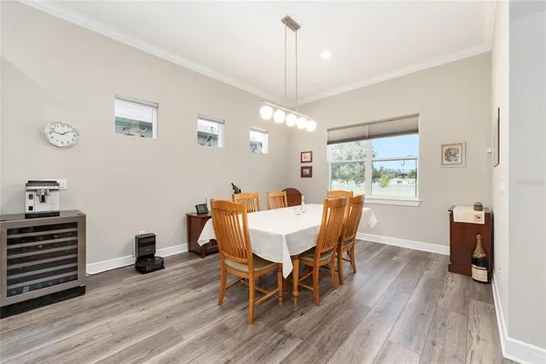 a dining room with furniture and a large window