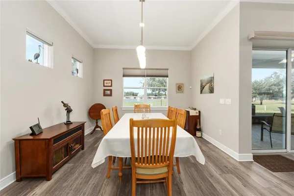 a dining room with furniture and a large window