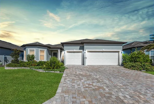 a front view of a house with a yard and garage