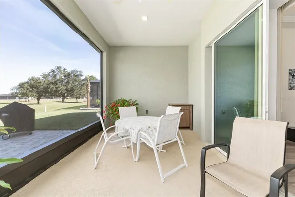 a spacious bedroom with a bed and a flat screen television