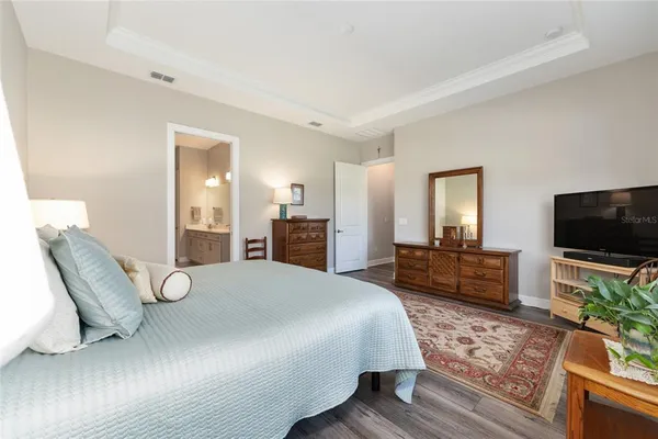 a spacious en suite bathroom with a double vanity sink a mirror and shower