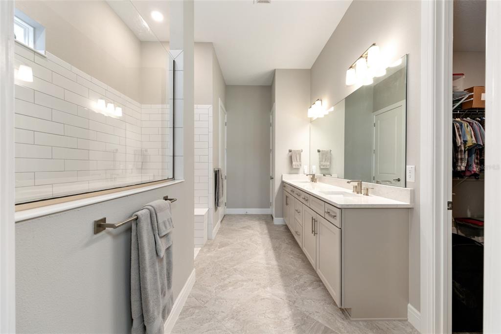 8843 Southwest 57th Pl Road Ocala, FL 34481 - Photo 30 of 64 a bathroom with a double vanity sink and mirror