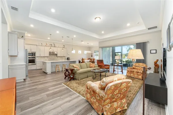 a living room with lots of furniture and kitchen view