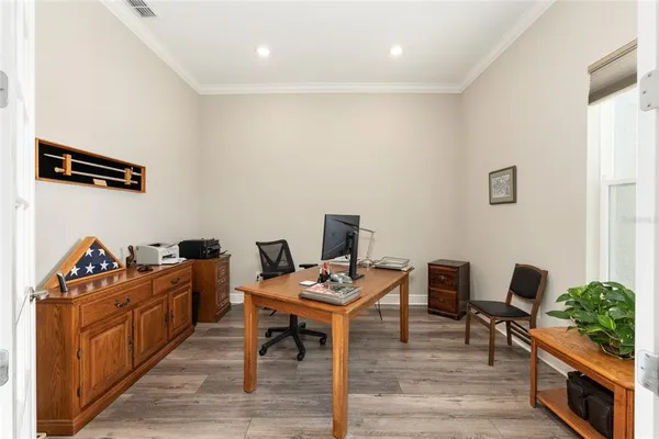 a view of a workspace with furniture and wooden floor
