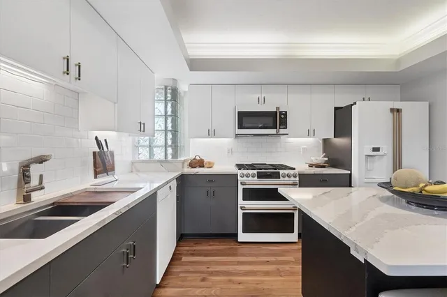 a kitchen with a sink stove and refrigerator