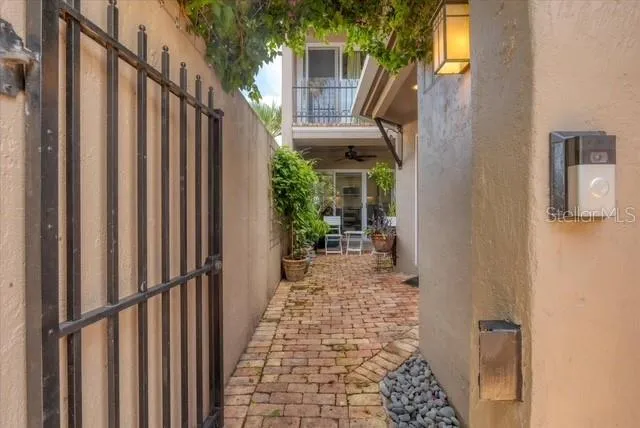 a view of a house with backyard and wooden door