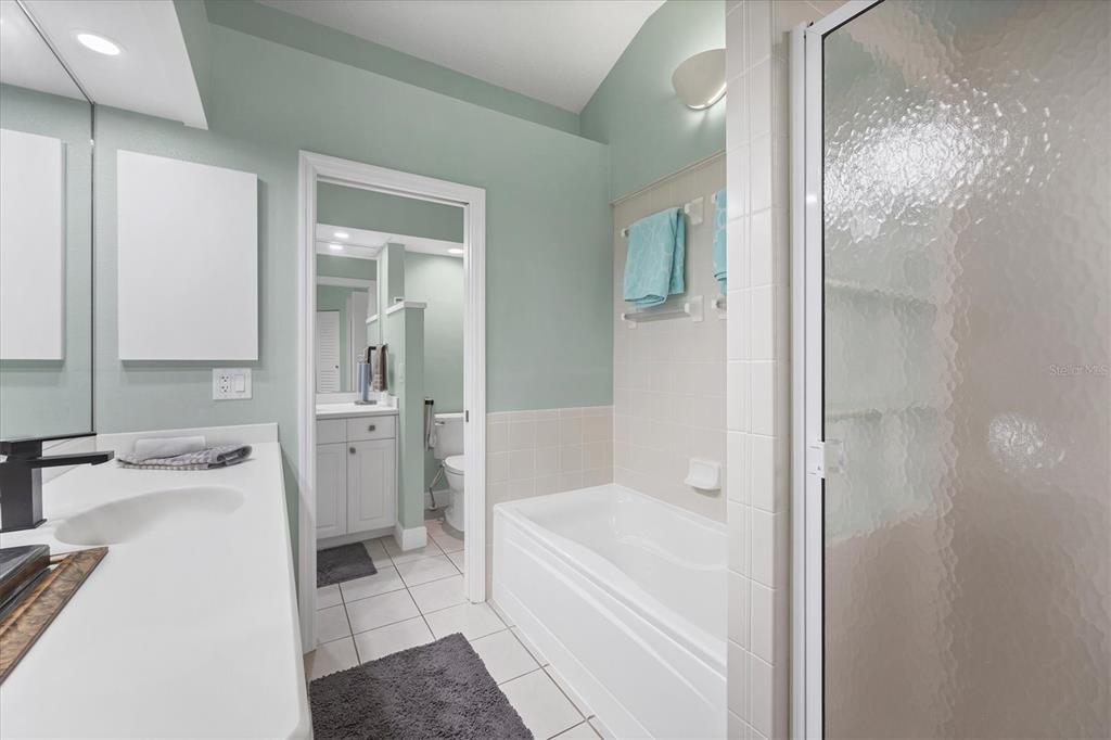 200 Cocoanut Avenue, Unit 7 Sarasota, FL 34236 - Photo 21 of 32 a bathroom with a tub sink and a mirror