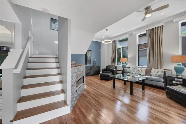 a living room with furniture and wooden floor