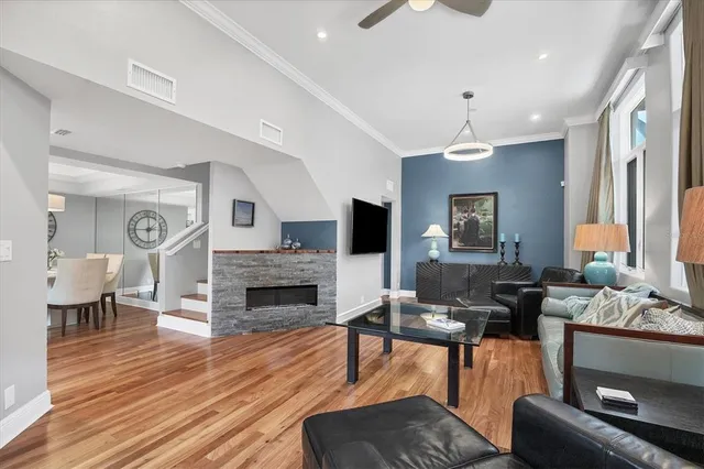 a living room with furniture flat screen tv and fireplace