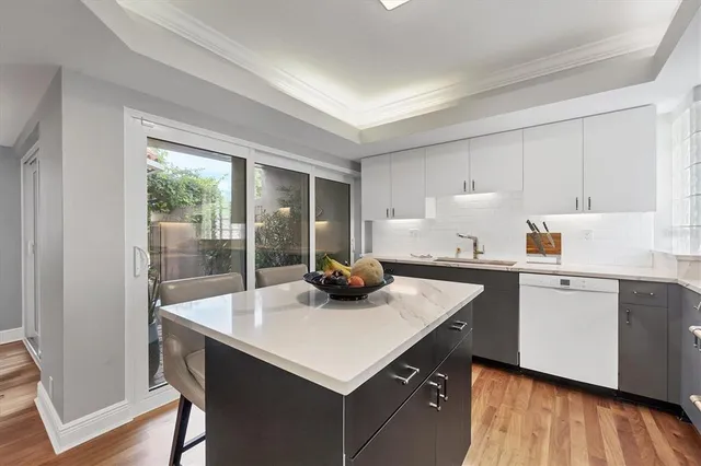 a kitchen with sink cabinets and wooden floor