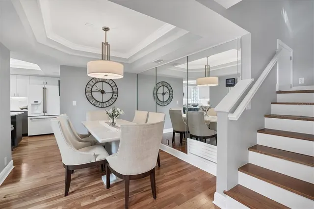 a view of a dining room with furniture clock and wooden floor