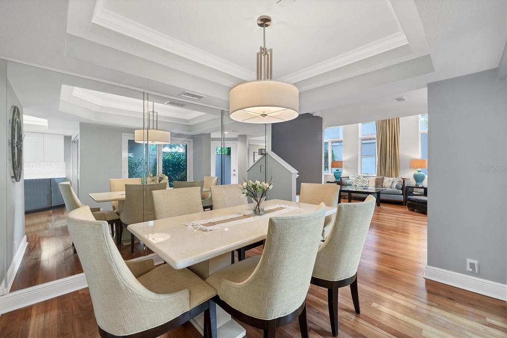 200 Cocoanut Avenue, Unit 7 Sarasota, FL 34236 - Photo 9 of 32 a view of a dining room with furniture window and wooden floor