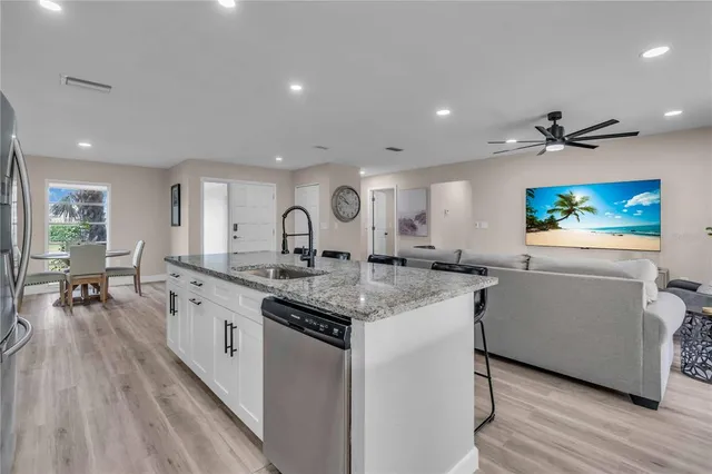 a kitchen with stainless steel appliances granite countertop a lot of counter space and a sink