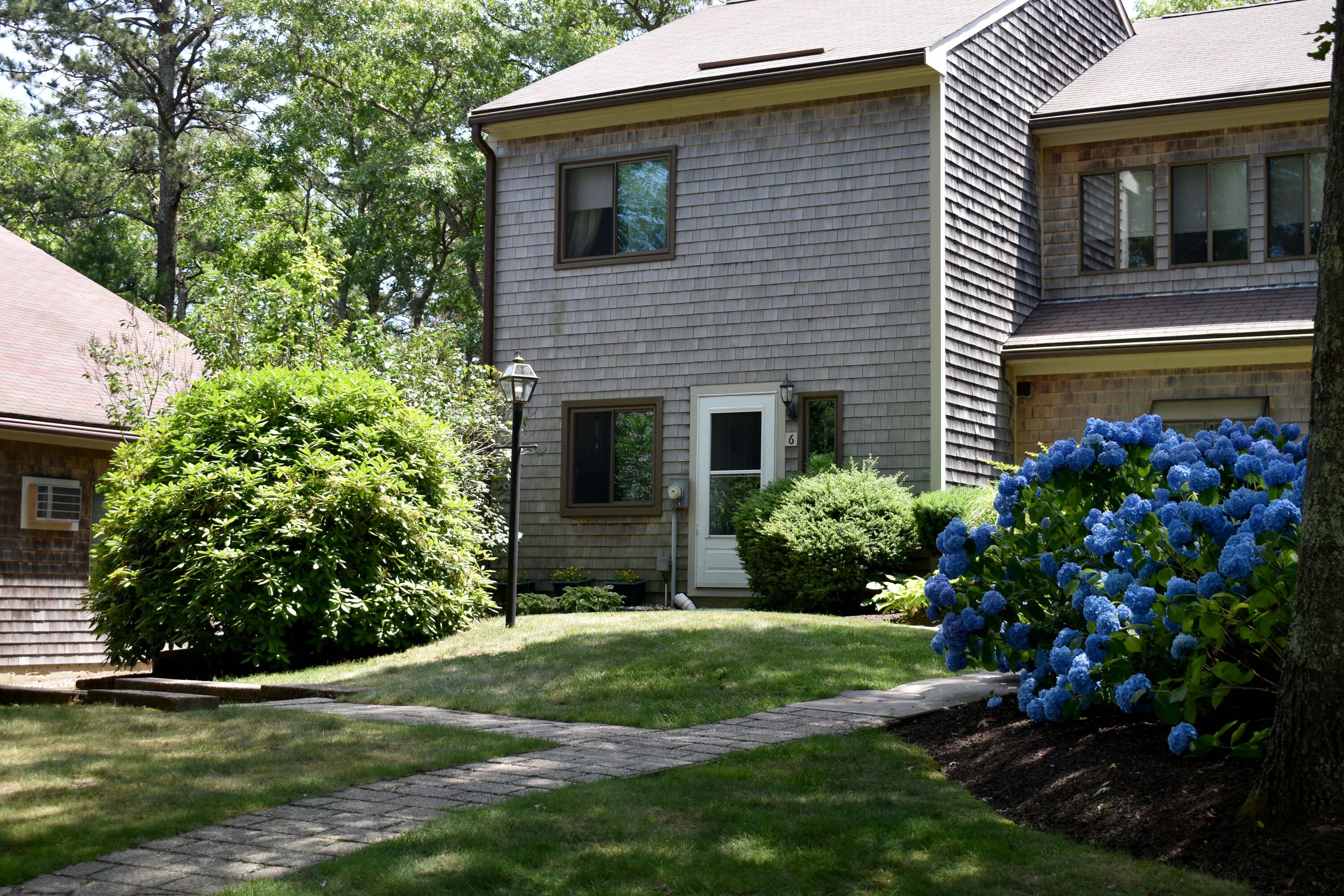 6 Round House Road Bourne, MA 02532 - Photo 1 of 25 a view of a house with a yard and potted plants