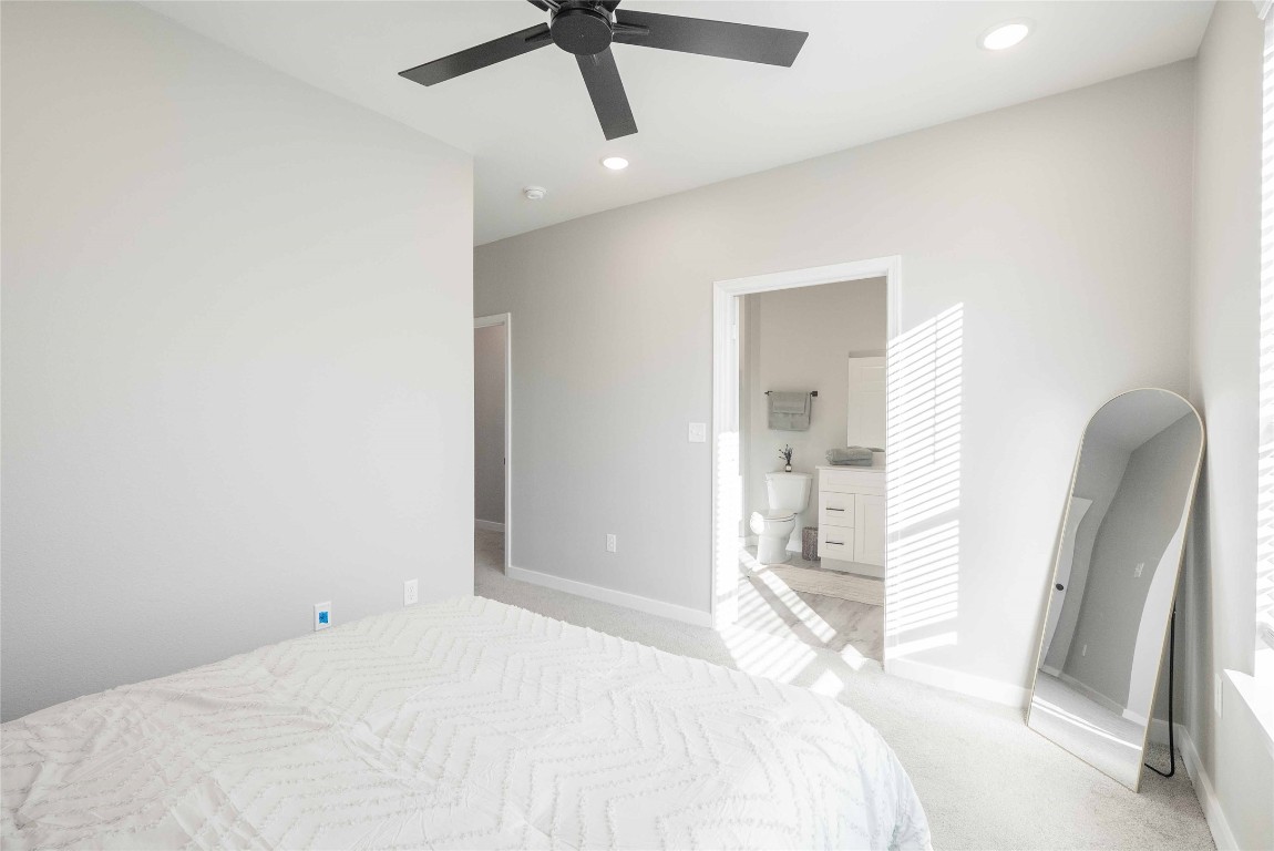 2101 Reinke Road, Unit 2106 Waller, TX 77484 - Photo 19 of 20 a bedroom with a bed and a large mirror