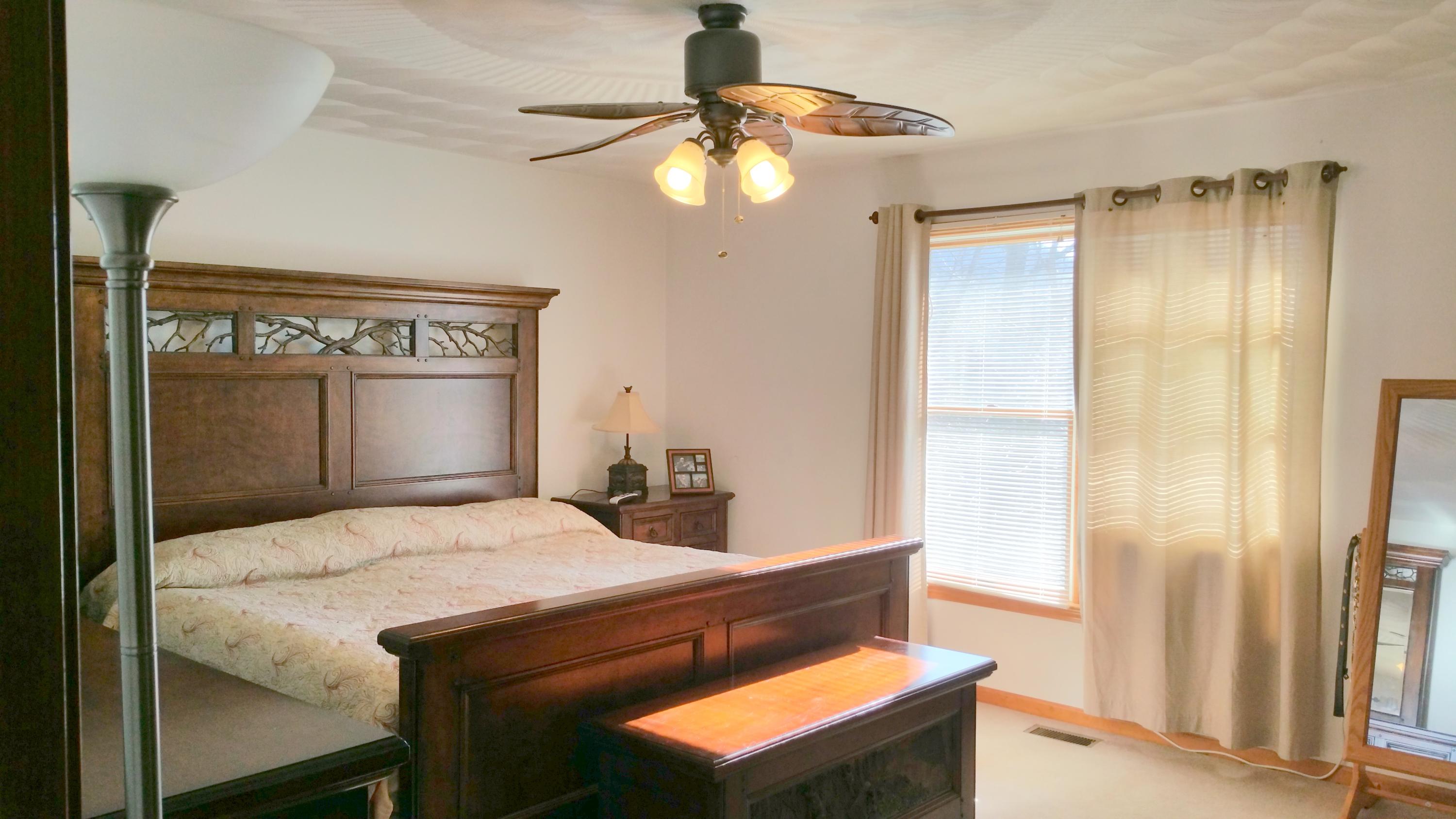 1354 Archway Road Blue Ridge, VA 24064 - Photo 8 of 22 a bedroom with a bed and a chandelier