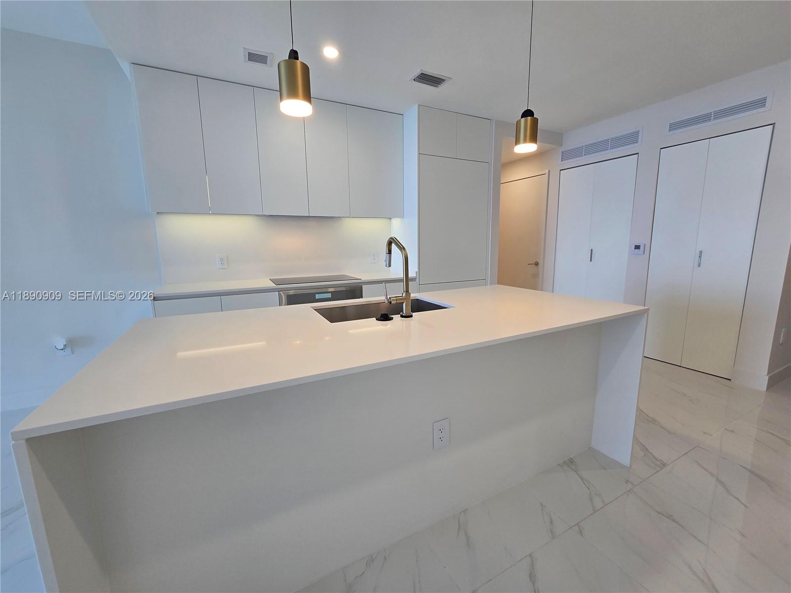 700 Northeast 24th Street, Unit 4004 Miami, FL 33137 - Photo 15 of 68 a bathroom with a sink a mirror and a shower